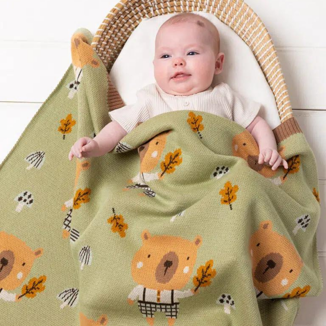 Baby wrapped in a knitted baby blanket in Australia